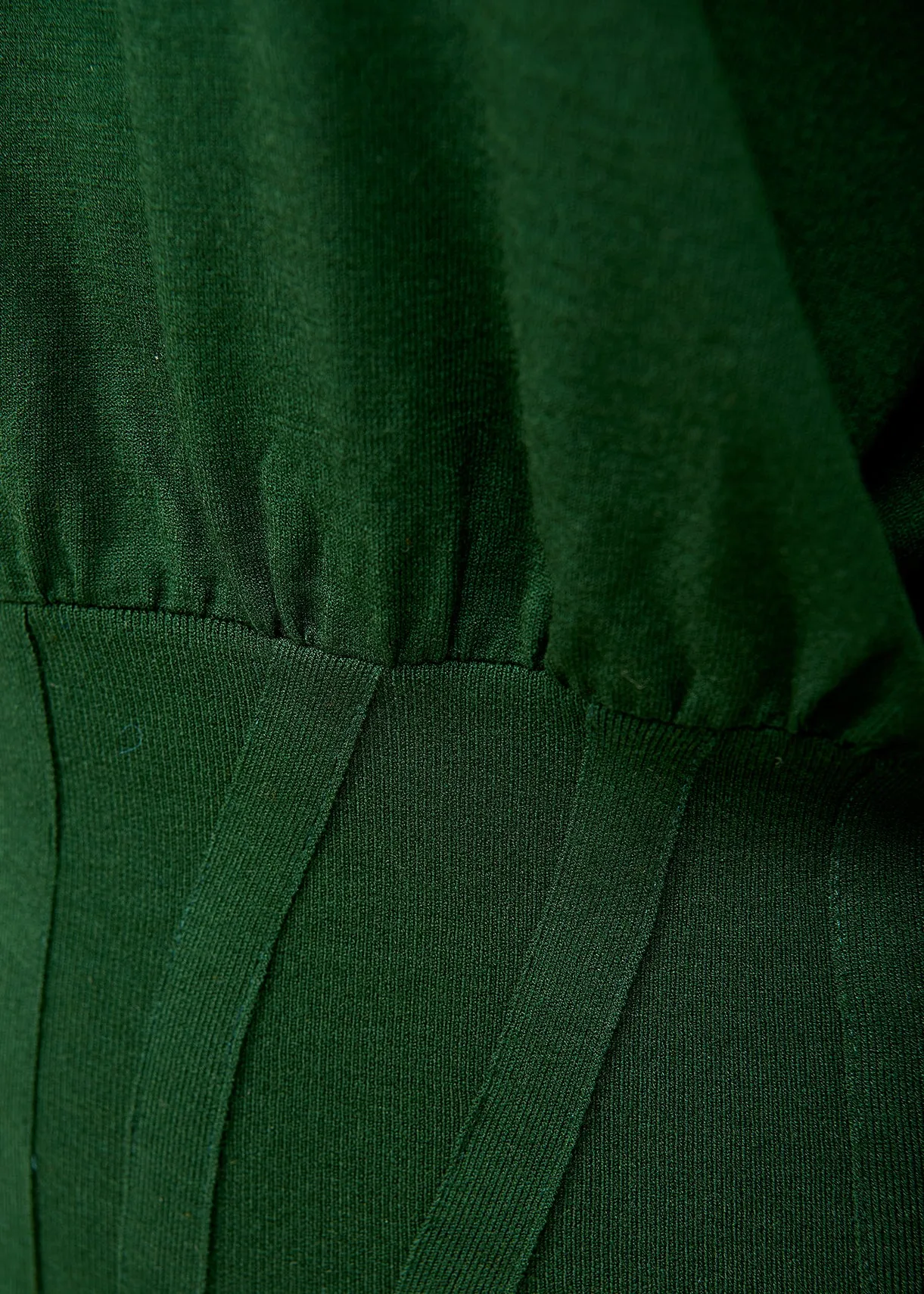 Dark green knitted sweater with fitted waist